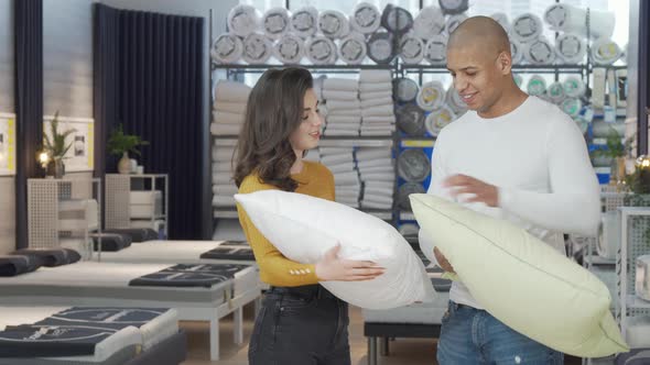 Lovely Couple Choosing New Pillows to Buy at Furnishings Store alt