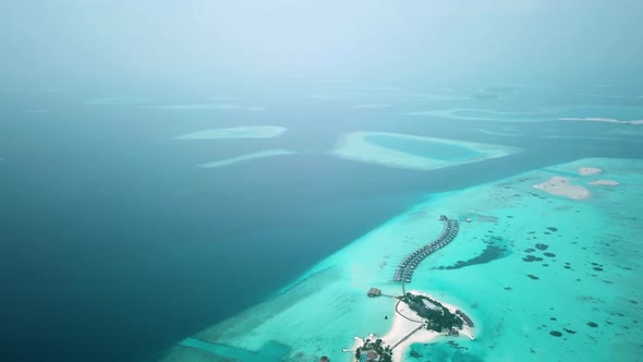 Aerial Drone View of a Beautiful Atoll or Island with a Resort in the Maldives alt