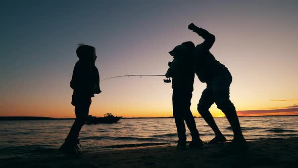 Children Are Having Fun with Their Dad While Fishing alt