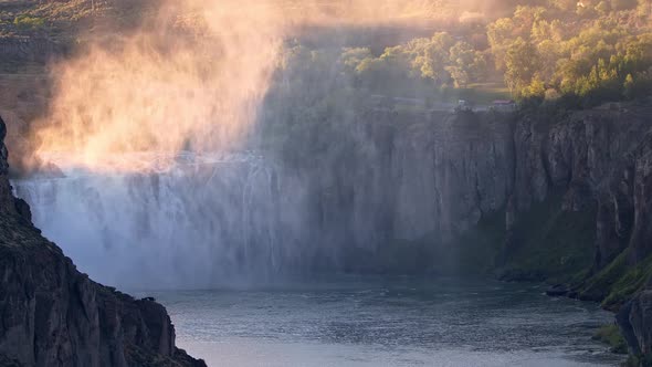Zoomed view of Shoshone Falls and viewing area as mist rises alt
