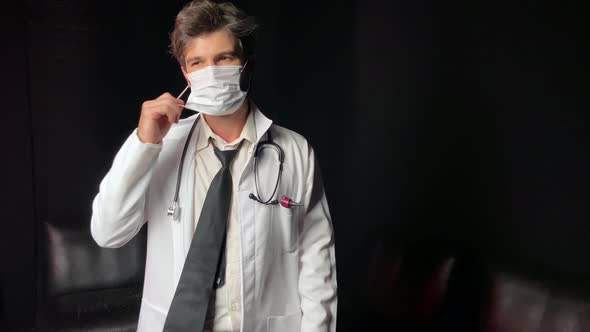 Tired Doctor Takes Off Mask After Surgery