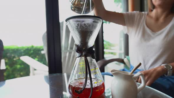 Woman drip coffee in the cafe