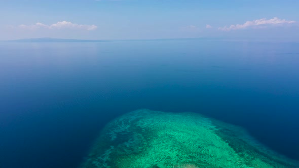 Island with a Tropical Beach and Turquoise Lagoons. Tropical Island on a Coral Reef, Top View. alt