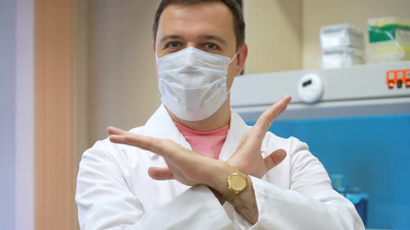 Male Chemical Laboratory Researcher Says No and Shakes His Head in Biomedical Laboratory alt