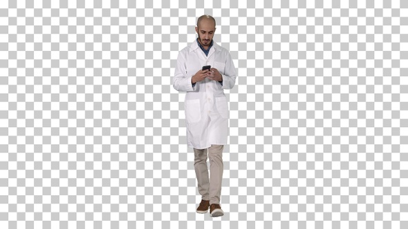 Male Arab Doctor Texting Message on The Phone While Walking alt