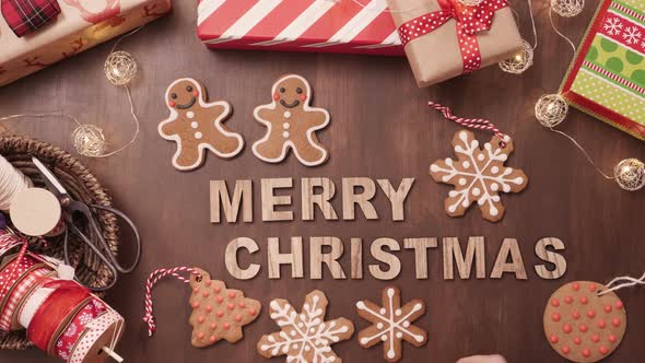 Wood Merry Christmas sign and traditional gingerbread cookies home made. alt