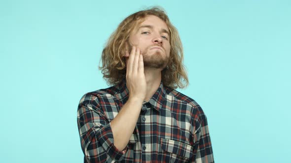 Slow Motion of Handsome Adult Man with Blond Wavy Hairstyle Touching Beard and Looking in Mirror