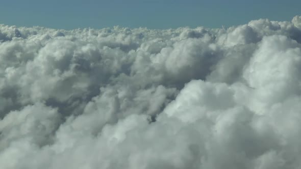 Flying above the clouds in a commercial airplane. Actual high altitude footage.