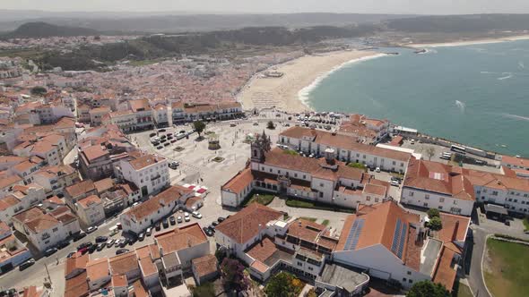 Cityscape of Nazare and beach in background, Portugal. Aerial circling alt