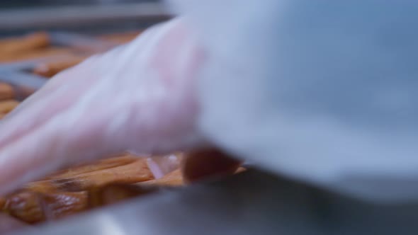 Close Up at the Worker's Hands Placing Readymade Sausages in Plastic Packages alt