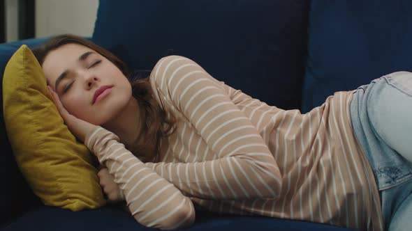 Exhausted Young Sleepy Woman Falling Down on Sofa