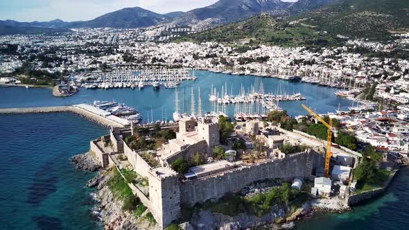 Amazing panoramic view from drone of full of yachts Bodrum harbour and ancient Kalesi castle.