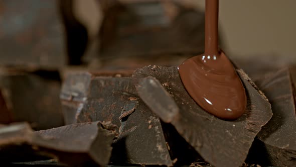 Super Slow Motion Shot of Pouring Melted Chocolate on Raw Chocolate Chunks at 1000 Fps. alt