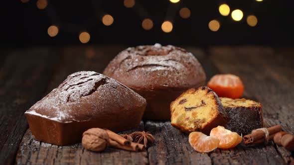 Three Christmas Bread Stollen with Tangerine on a Wooden Textured Table Against the Background of alt