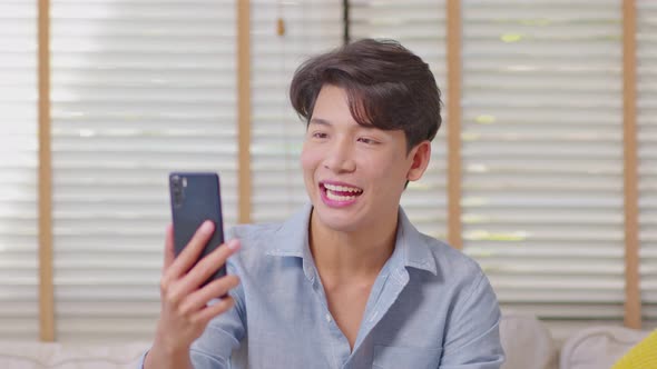 Asian handsome man meeting with business team via video conference call at Home alt