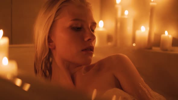A Woman Lies in a Hot Bath By Candlelight