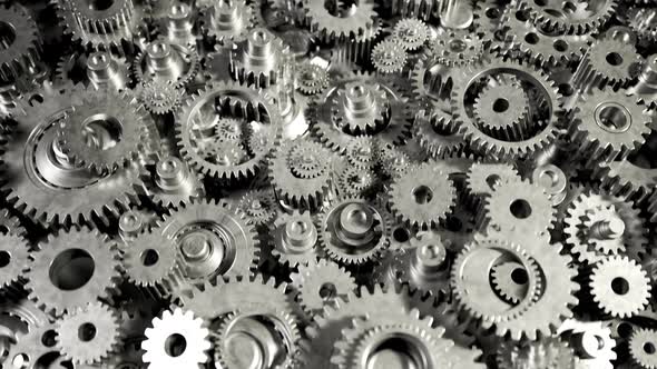 Seamless loop animation of a bunch of dark metallic gears laying on the heap. alt