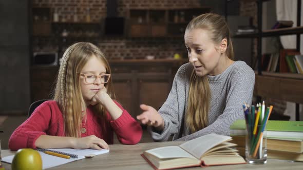 Bored Girl Unwilling To Do Homework with Mother alt