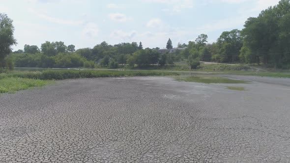 Aerial view of a dry ground near a lake alt