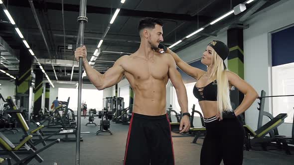 Attractive Sport Couple Man and Woman on the Gym Background alt