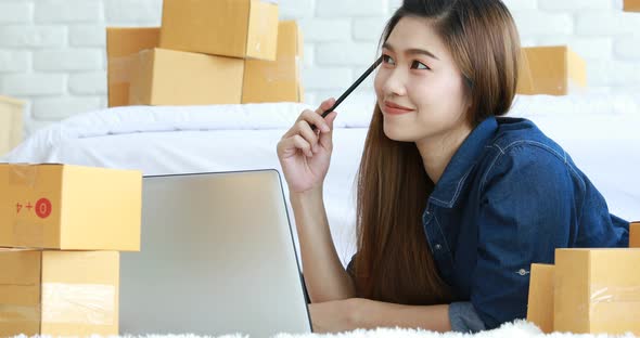 entrepreneur Young Asian women working with laptop thinking for marketing Online shopping alt
