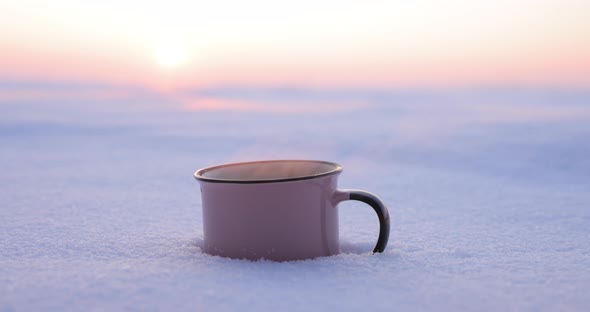 Pours Tea From a Thermos Into a Cup on a Snowy Day