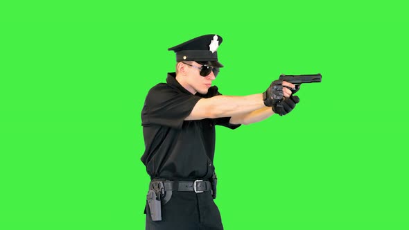 Caucasian Policeman Walks Gets the Gun Out Shoots and Reloads on a Green Screen Chroma Key