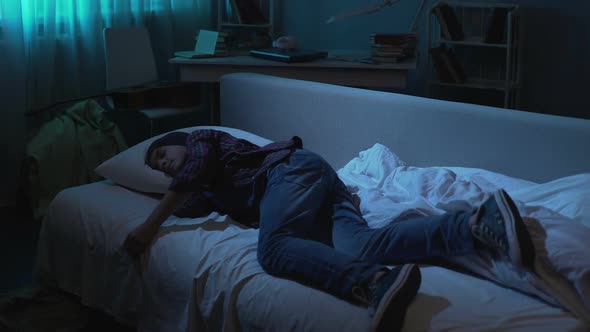 Male Teenager in Outwear Sleeping on Sofa After Night Party, Difficult Age alt