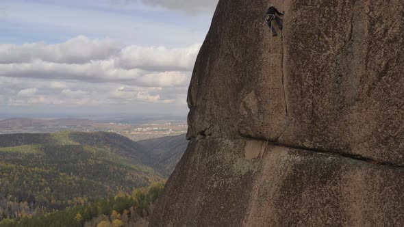 Risky Climb on a Rock Crack on a Vertical Wall.