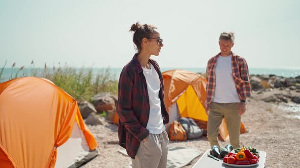 Happy Couple Meeting Morning at Seaside Camping Next to Tents alt