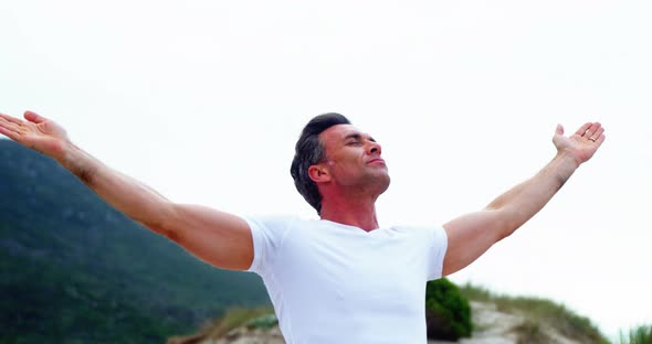 Mature man with arms outstretched alt