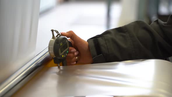 Laboratory Assistant in the Production of Polyethylene Measures the Thickness of the Film. Close-up alt