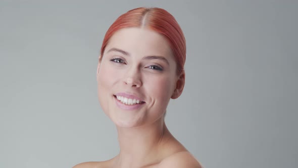 Studio portrait of young, beautiful and natural redhead woman. Beauty concept. alt