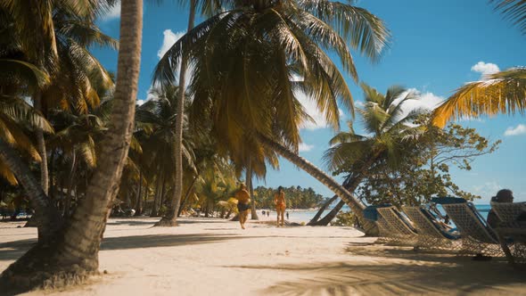 Sexy Woman and Man Walking at the White Beach in Saona alt