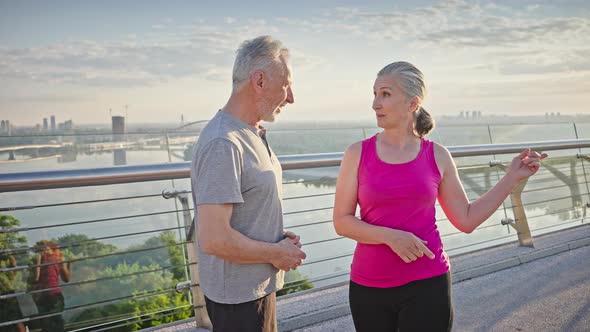 Senior Man and Woman Enjoy Conversation After Training alt
