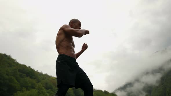 Boxer is Training Alone in Nature Naked Muscular Torso of Sporty Man alt