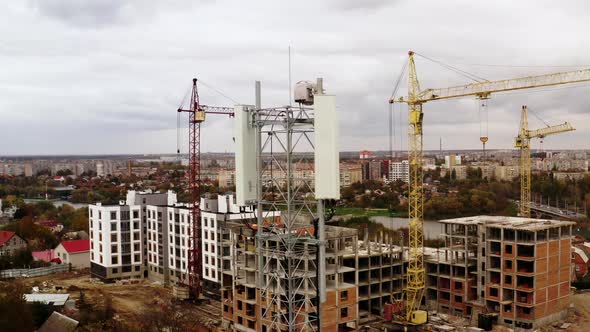 Aerial view of 4G and 5G telecommunications tower cellular network antenna on the roof.