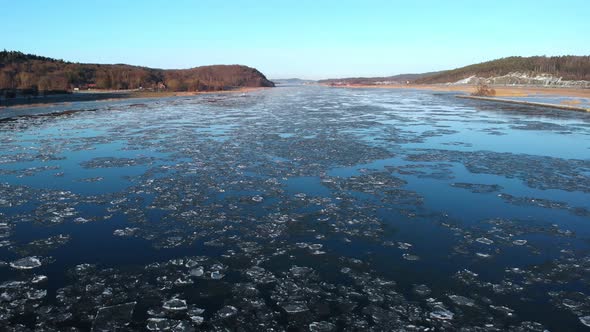 River Melting Ice And Clear Blue Sky Climate Change Concept Aerial Backward