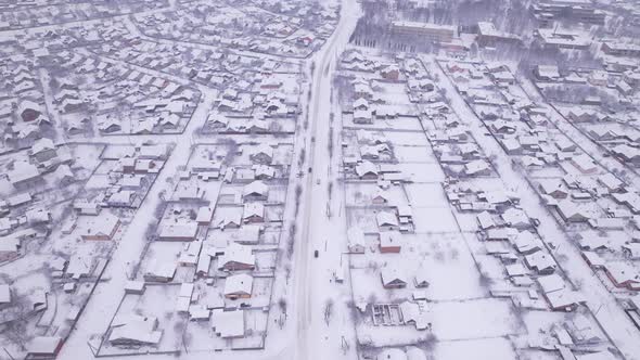 Aerial view of the snow village with private houses and garden plots at winter alt