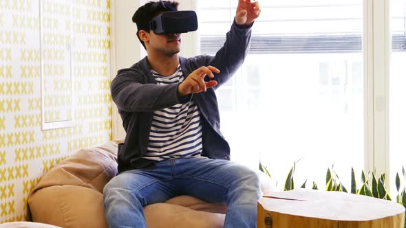 Business executive using virtual reality headset alt