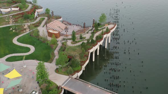 An aerial view over Manhattan's Little Island, a public green space. The shot was taken early in the alt