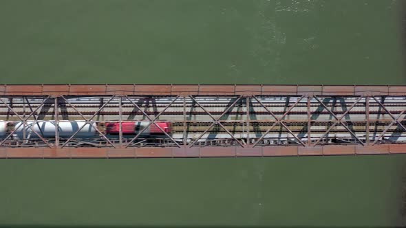 Bird's Eye View of a Freight Train Crossing A Bridge alt