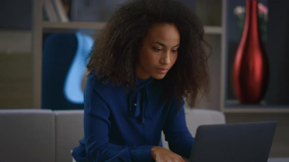 Focused African American Businesswoman Typing Laptop Answering Call in Office alt