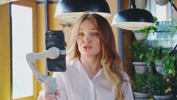 Young Lady Recording Video for Social Network on Mobile alt