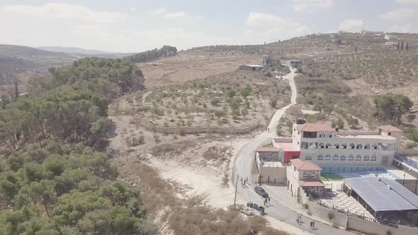 Aerial view of a building with a dried up pool in Arraba Palestine alt