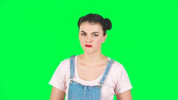 Girl Listens with Approval and Shows a Like Sign on Green Screen, Slow Motion alt