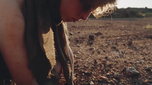 Dystopian Woman Looking at Reflection in Piece of Broken Mirror alt