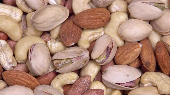 Close Up. Background of Nuts. Different Types of Nuts Rotate in a Circle