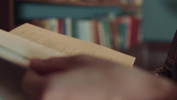 The Girl's Hands Open the Book and Flip Through the Pages the Girl Gets Acquainted with the Contents alt