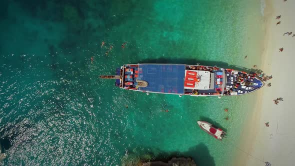 Aerial view of people disembarking off ferry, Ithaki island, Greece. alt